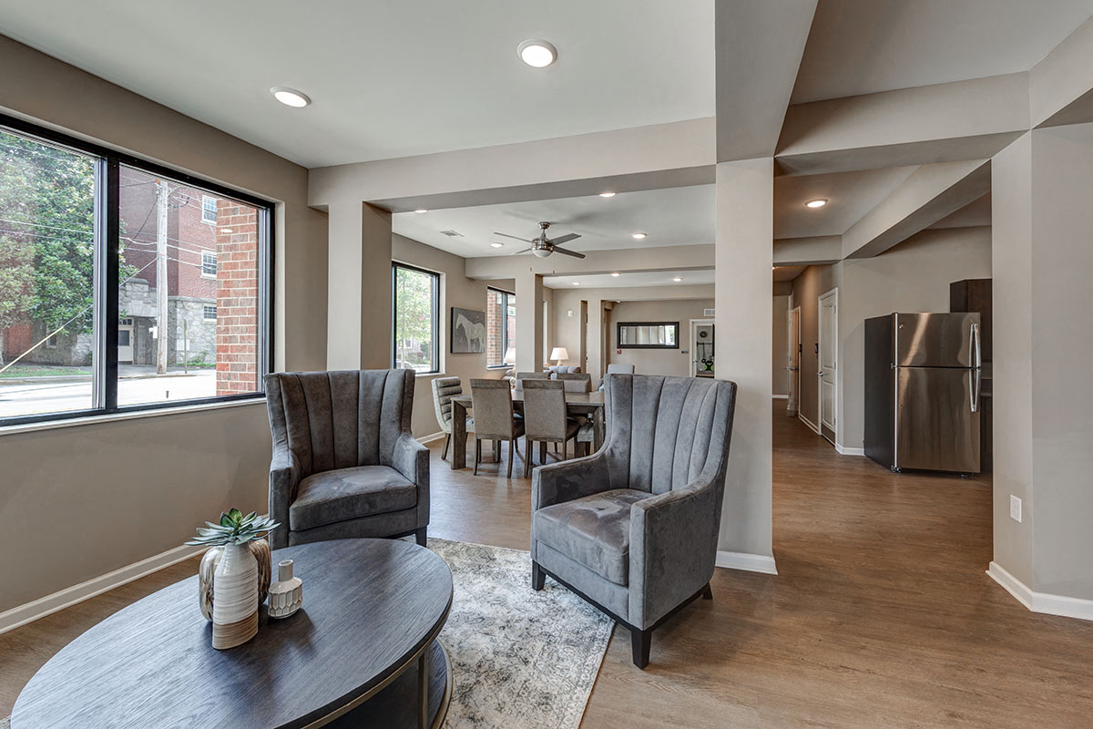 a living room and dining room with a table and chairs